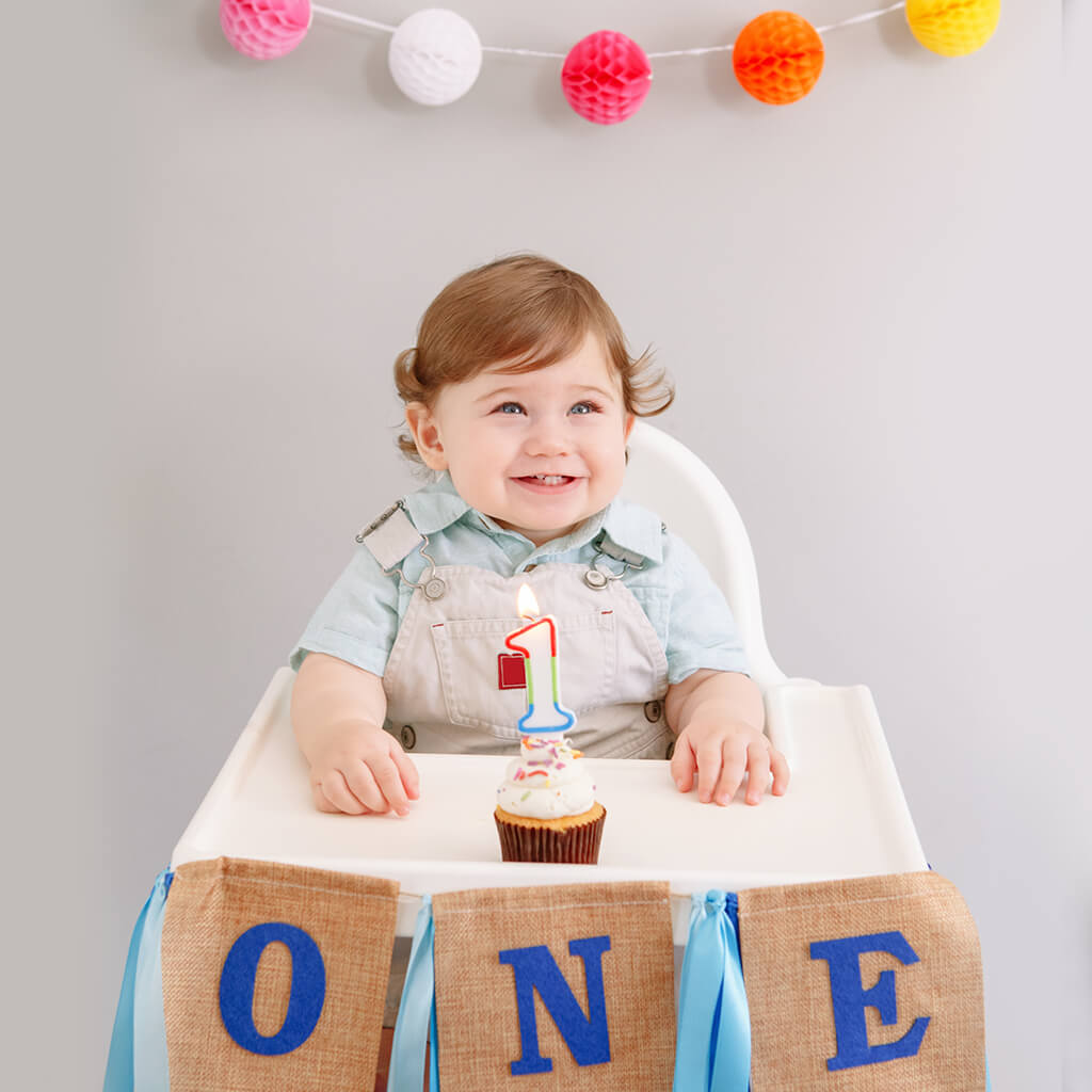 Loving parents and baby daughter posing at first birthday party Stock Photo  - Alamy