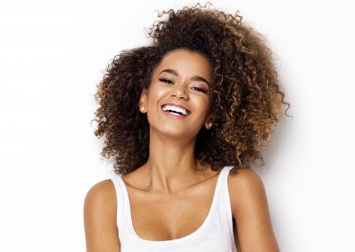 before and after retouch curly haired girl on a white background