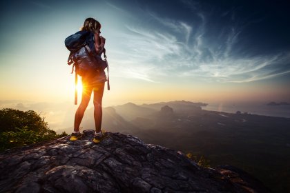 retouching before and after tourist with a backpack on a sunset background