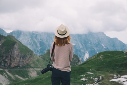 before and after retouching girl with a camera on the background of mountains